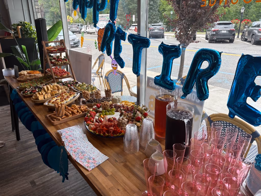 Catered appetizer buffet with charcuterie, deviled eggs, and refreshments for a private celebration at Bean and Barrel