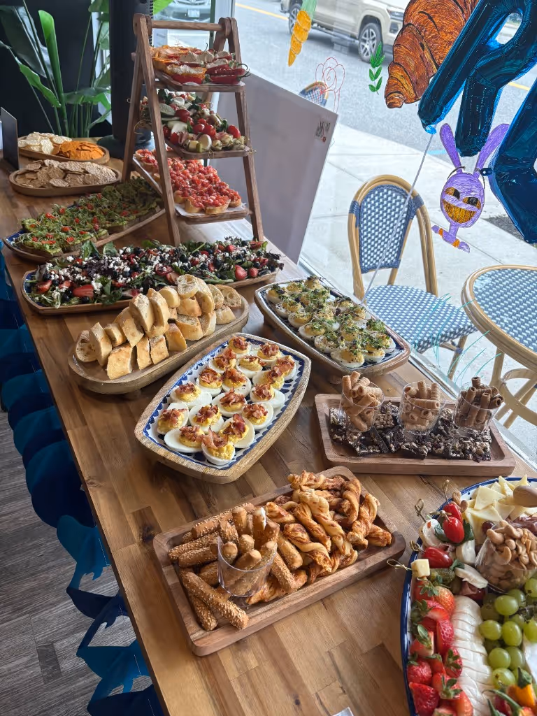 Three-tier appetizer stand with bruschetta, caprese skewers, and platters of finger food for a gathering